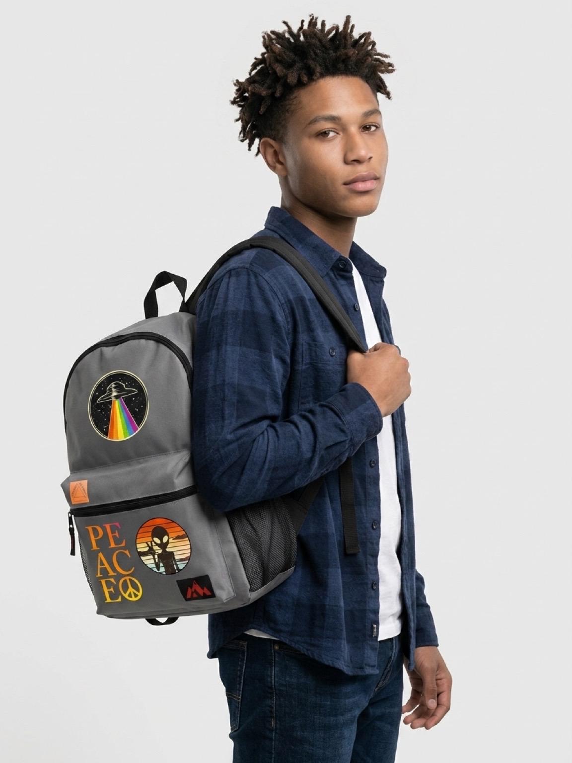 Gray backpack with black trim and alien graphic front pocket, worn on the back