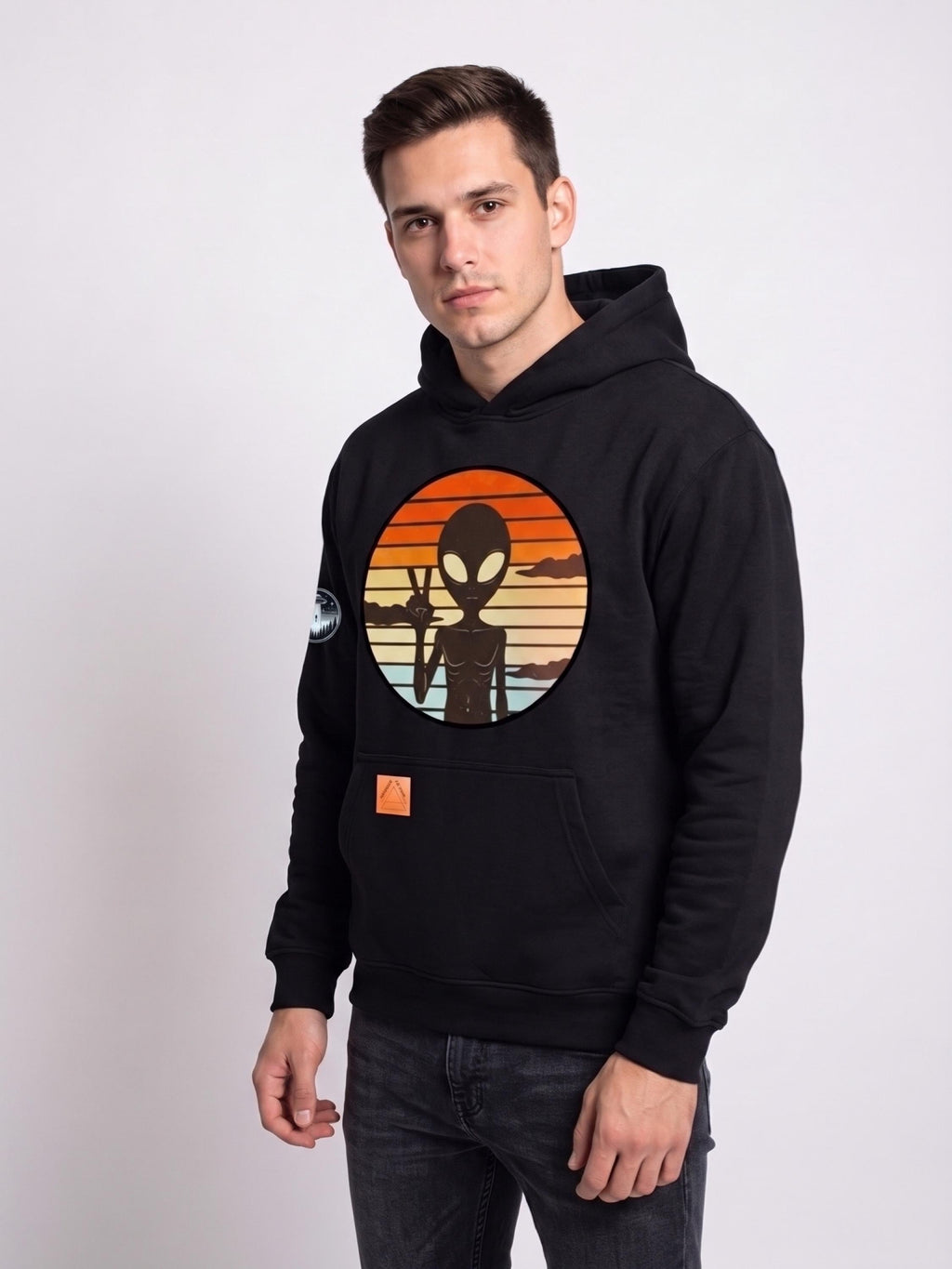 Black cotton hoodie with circular UFO astronaut graphic, front pocket, and orange label