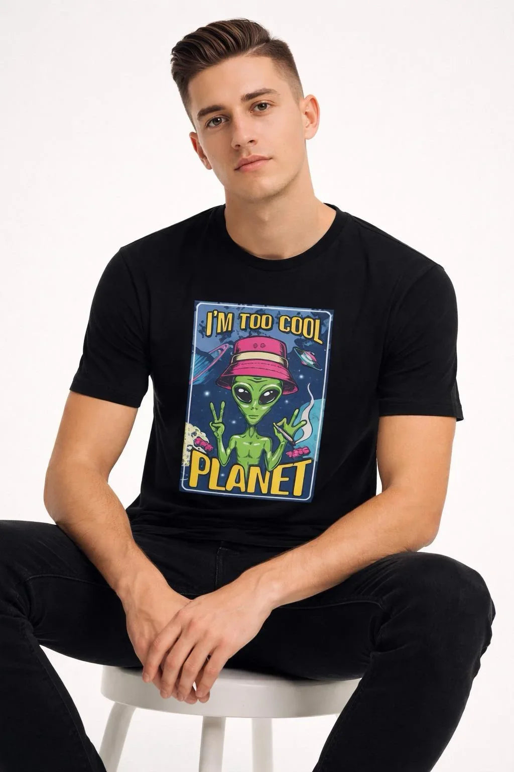 Man wearing a black unisex crewneck t-shirt with a cool alien graphic print.