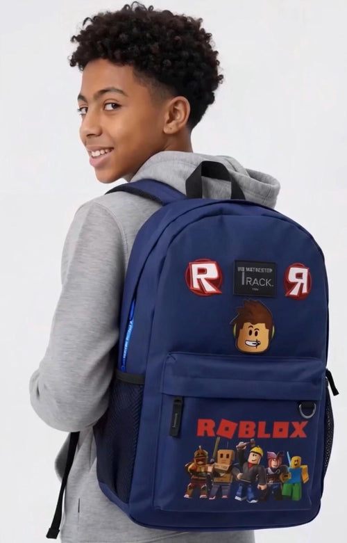 A boy wearing a gray hoodie and black pants is shown from the back, wearing a navy blue gaming backpack 